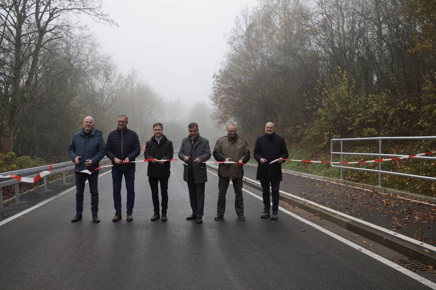 6 Personen stehen auf einer Straße und schneiden ein Asperrband durch, das über die Straße gespannt ist. 6 Personen stehen auf einer Straße und schneiden ein Asperrband durch, das über die Straße gespannt ist.