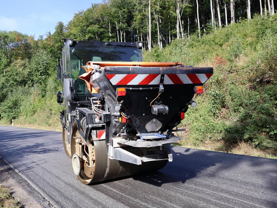 Baumaschine im Trecktal Baumaschine glättet den neuen Straßenbelag der Kreisstraße im Trecktal